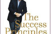 Reading in a book : '' The Success Principles '' by Jack Canfield .